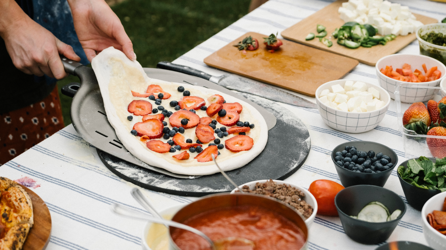 Backyard Pizza Party preparing the pizza with toppings on the side recipe poster image