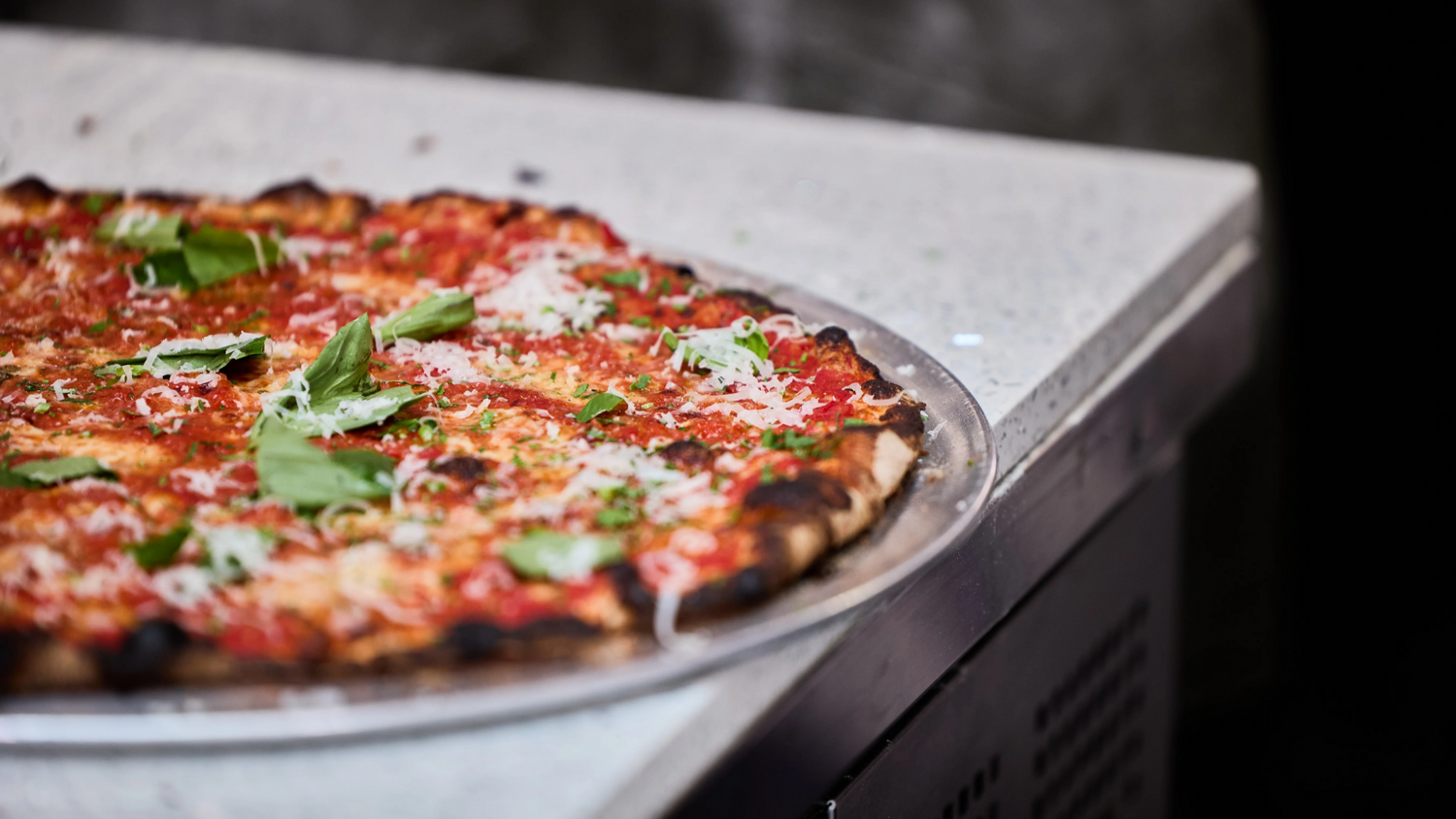 tavern style pizza on the edge of a counter